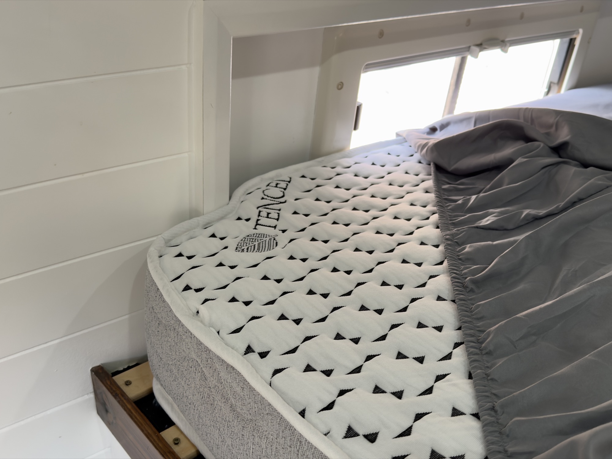 Custom mattress fitted in our Peugeot Boxer campervan, viewed from the rear doors